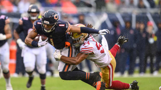 Sep 11, 2022; Chicago, Illinois, USA; Chicago Bears quarterback Justin Fields (1) runs the ball and is tackled by San Francisco 49ers middle linebacker Fred Warner (54) at Soldier Field.