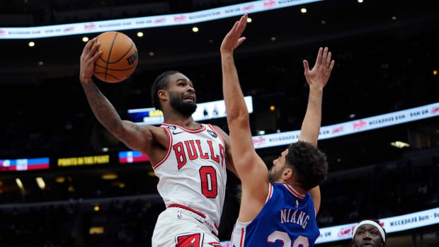 Oct 29, 2022; Chicago, Illinois, USA; Chicago Bulls guard Coby White (0) shoots the ball against Philadelphia 76ers forward Georges Niang (20) during the first half at United Center.