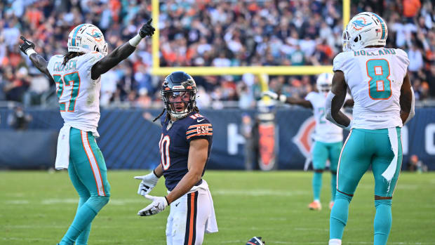 Nov 6, 2022; Chicago, Illinois, USA; Chicago Bears wide receiver Chase Claypool (10) looks for a call from the referee after Miami Dolphins defensive back Keion Crossen (27) and safety Jevon Holland (8) break up a pass in the fourth quarter at Soldier Field. Miami defeated Chicago 35-32. Mandatory Credit: Jamie Sabau-USA TODAY Sports