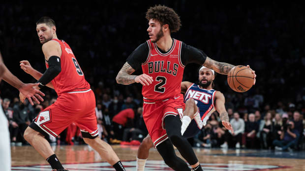 Dec 4, 2021; Brooklyn, New York, USA; Chicago Bulls guard Lonzo Ball (2) dribbles as Brooklyn Nets guard DeAndre' Bembry (95) is screened by center Nikola Vucevic (9) during the first half at Barclays Center.