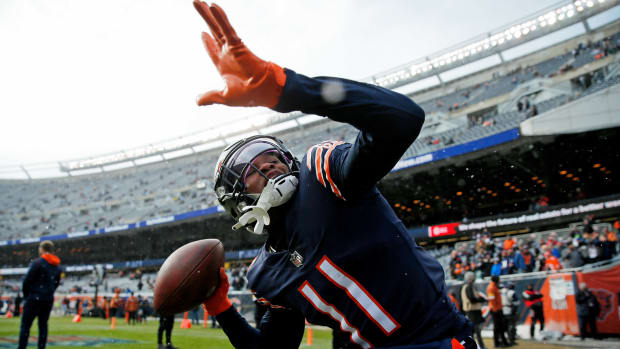 Jan 2, 2022; Chicago, Illinois, USA; Chicago Bears wide receiver Darnell Mooney (11) throws the ball into the stands as he plays catch with fans during warmups before the game against the New York Giants at Soldier Field. Mandatory Credit: Jon Durr-USA TODAY Sports