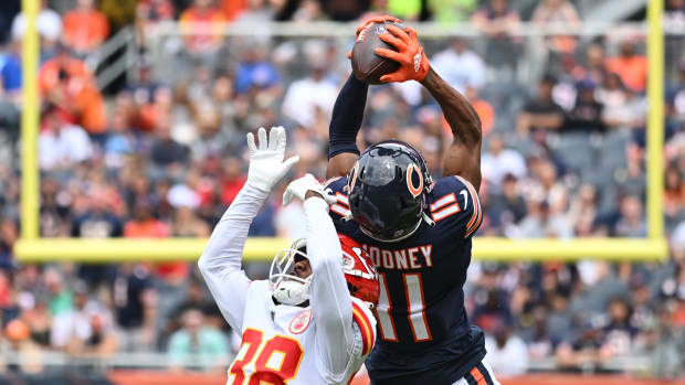 Aug 13, 2022; Chicago, Illinois, USA; Chicago Bears wide receiver Darnell Mooney (11) pulls in a 26-yard reception over Kansas City Chiefs cornerback L'Jarius Sneed (38) in the first quarter at Soldier Field.