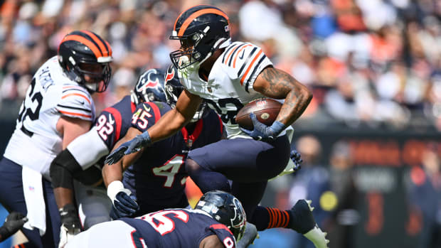 Sep 25, 2022; Chicago, Illinois, USA; Chicago Bears running back David Montgomery (32) leaps through the line for a five yard gain in the first quarter against the Houston Texans at Soldier Field. Mandatory Credit: Jamie Sabau-USA TODAY
