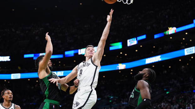 Apr 17, 2022; Boston, Massachusetts, USA; Brooklyn Nets guard Goran Dragic (9) shoots against Boston Celtics forward Jayson Tatum (0) in the second quarter during game one of the first round for the 2022 NBA playoffs at TD Garden.