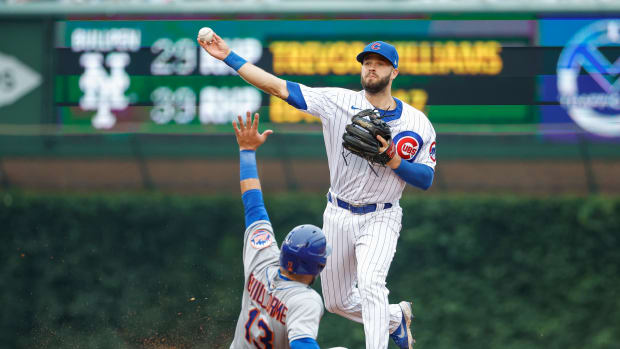 Chicago Cubs infielder David Bote turns a double play against the New York Mets