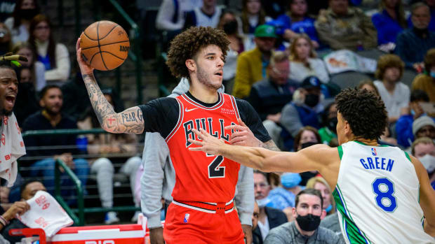 Jan 9, 2022; Dallas, Texas, USA; Chicago Bulls guard Lonzo Ball (2) looks to pass the ball by Dallas Mavericks guard Josh Green (8) during the second quarter at the American Airlines Center.