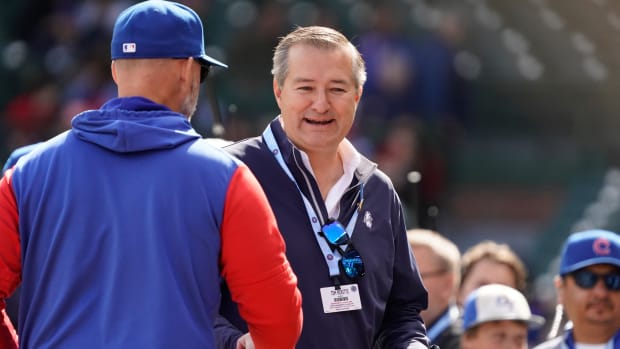 Oct 2, 2022; Chicago, Illinois, USA; Chicago Cubs owner Tom Ricketts, right, talks with manager David Ross (3) before the game against the Cincinnati Reds at Wrigley Field.
