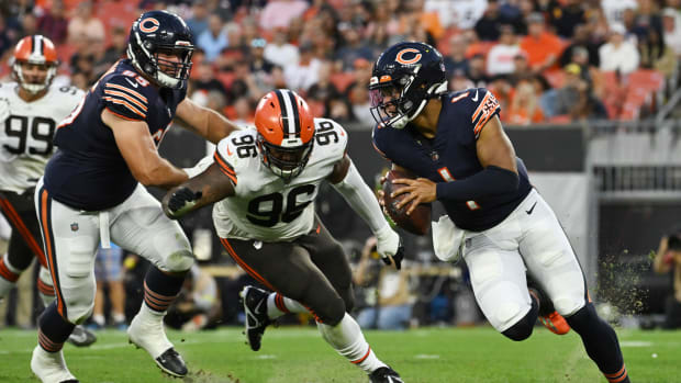 Aug 27, 2022; Cleveland, Ohio, USA; Chicago Bears quarterback Justin Fields (1) scrambles away from Cleveland Browns defensive tackle Jordan Elliott (96) during the first half at FirstEnergy Stadium.