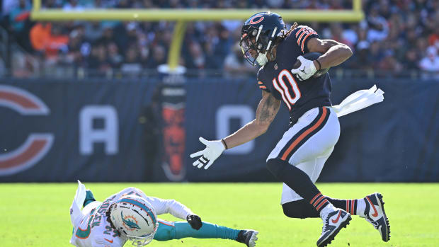 Nov 6, 2022; Chicago, Illinois, USA; Chicago Bears wide receiver Chase Claypool (10) avoids a tackle attempt from Miami Dolphins defensive back Keion Crossen (27) in the first quarter at Soldier Field. Mandatory Credit: Jamie Sabau-USA TODAY Sports