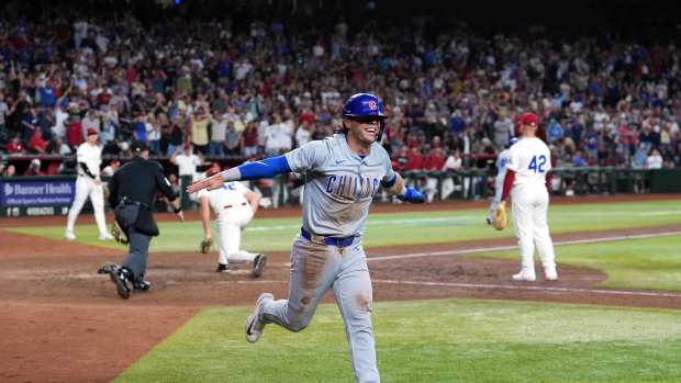 Apr 15, 2024; Phoenix, Arizona, USA; Chicago Cubs second baseman Nico Hoerner celebrates after scoring a run against the Arizona Diamondbacks during the ninth inning at Chase Field. All players wore number 42 to commemorate Jackie Robinson Day.