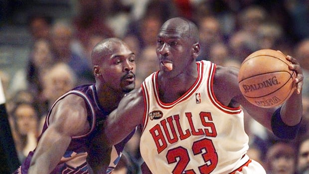 June 12, 1998; Chicago, IL, USA; Chicago Bulls guard Michael Jordan (23), right, goes up against Utah Jazz player Bryon Russell (3) in Game 5 of the 1998 NBA Finals.