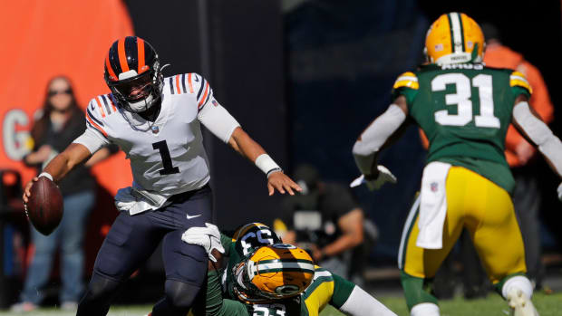 Green Bay Packers linebacker Jonathan Garvin (53) tackles Chicago Bears quarterback Justin Fields (1) in the second quarter as safety Adrian Amos (31) moves in on the play during their football game Sunday, October 17, 2021, at Soldier Field in Chicago, Ill. Green Bay won 24-14.