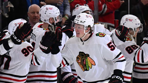 Dec 21, 2022; Chicago, Illinois, USA; Chicago Blackhawks forward MacKenzie Entwistle (58) celebrates at the bench after scoring a goal in the second period against the Nashville Predators at United Center.