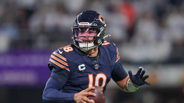 Dec 16, 2024; Minneapolis, Minnesota, USA; Chicago Bears quarterback Caleb Williams (18) scrambles against the Minnesota Vikings in the fourth quarter at U.S. Bank Stadium.