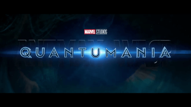 The title card for Antman and the Wasp: Quantumania. The word Quantumania has a blue glow behind it and it sits on top of the words Antman and the Wasp.