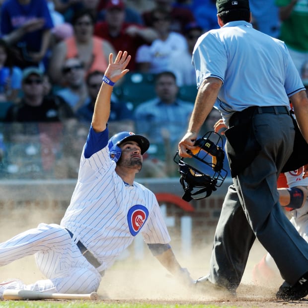 Aug 18, 2013; Chicago, IL, USA; Chicago Cubs center fielder David DeJesus (9) protests being called out as he slides through home plate during the eighth inning against the St. Louis Cardinals at Wrigley Field. Mandatory Credit: Reid Compton-USA TODAY Sports