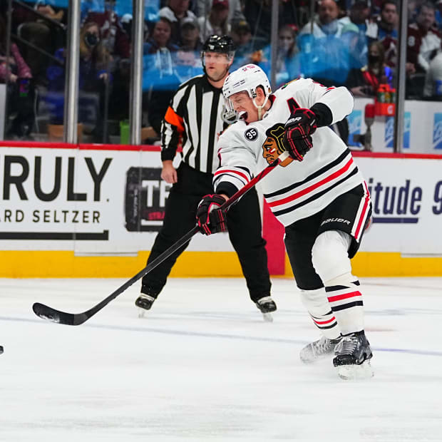 Oct 13, 2021; Denver, Colorado, USA; Chicago Blackhawks defenseman Connor Murphy (5) shoots the puck in the first period against the Colorado Avalanche at Ball Arena.