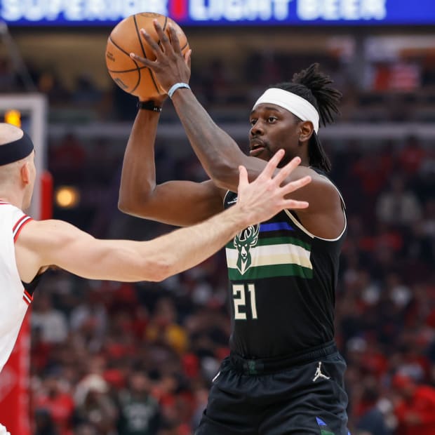 Apr 22, 2022; Chicago, Illinois, USA; Chicago Bulls guard Alex Caruso (6) defends against Milwaukee Bucks guard Jrue Holiday (21) during the first half of game three of the first round for the 2022 NBA playoffs at United Center.