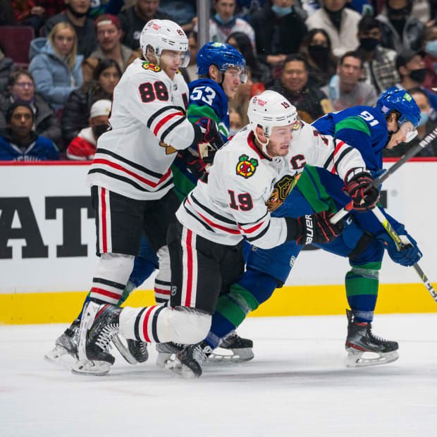 Nov 21, 2021; Vancouver, British Columbia, CAN; Chicago Blackhawks forward Patrick Kane (88) and Vancouver Canucks forward Bo Horvat (53) look on as forward Juho Lammikko (91) strips the puck from forward Jonathan Toews (19) in the second period at Rogers Arena.