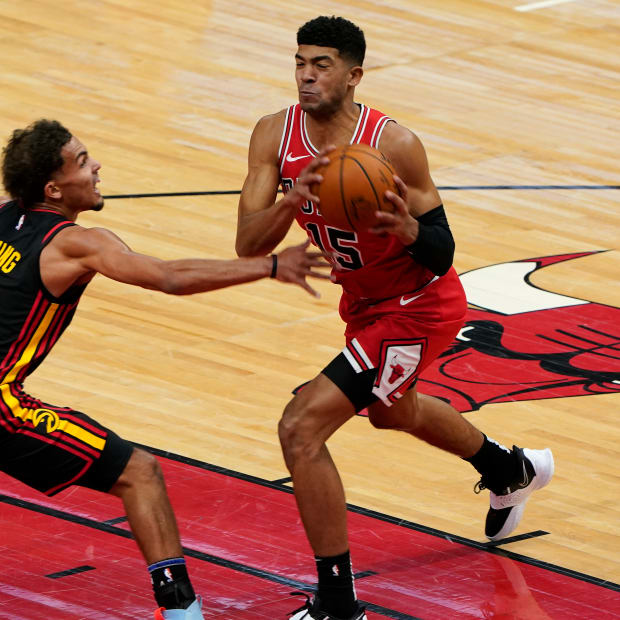 Dec 23, 2020; Chicago, Illinois, USA; Chicago Bulls forward Chandler Hutchison (15) attempts to shoot the ball on Atlanta Hawks guard Trae Young (11) during the first half at the United Center.