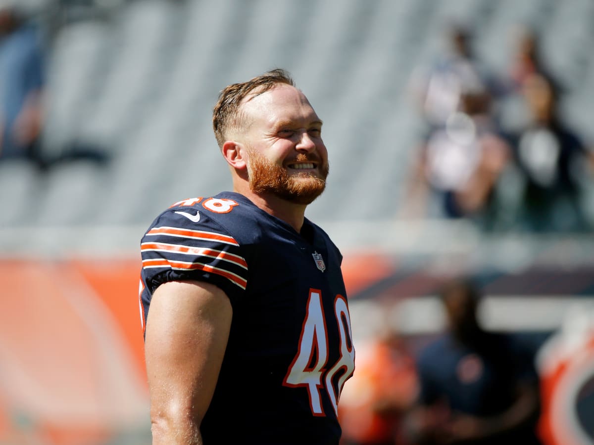 Chicago Bears long snapper Patrick Scales holds his daughter