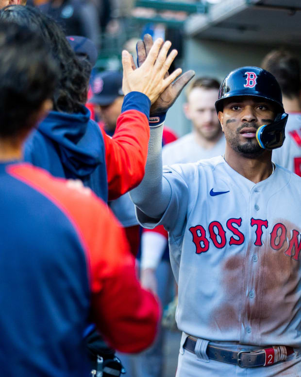 Jun 11, 2022; Seattle, Washington, USA; Boston Red Sox shortstop Xander Bogaerts (2) is greeted in the dugout after scoring against the Seattle Mariners during the first inning at T-Mobile Park.