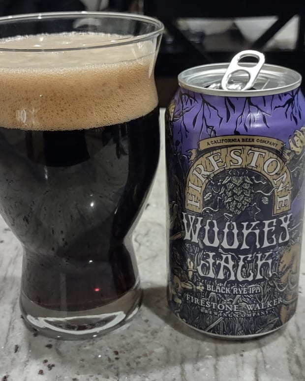 A Firestone Walker Wookey Jack can with the beer poured into a glass next to it