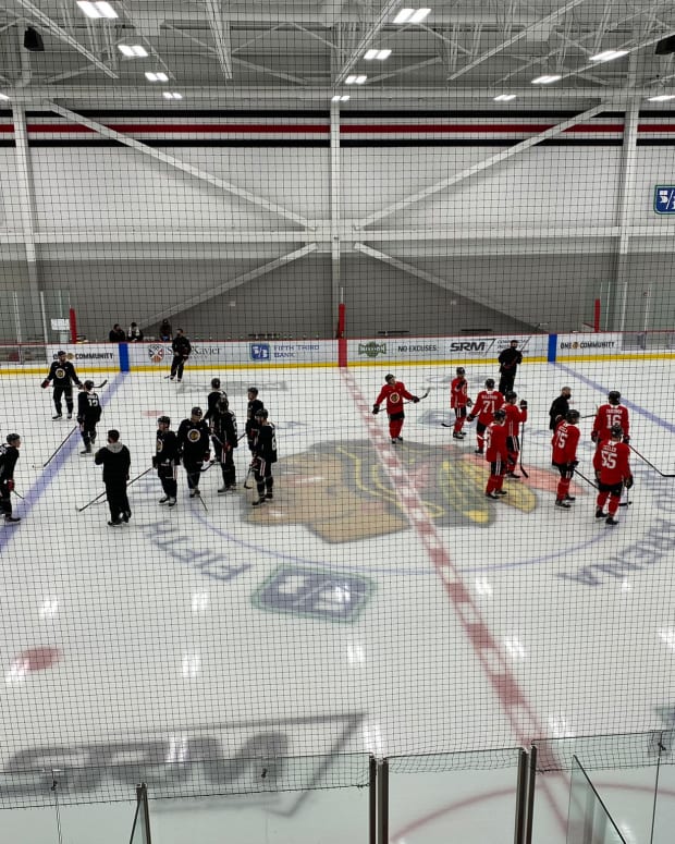 Chicago Blackhawks players gather on the ice at training camp