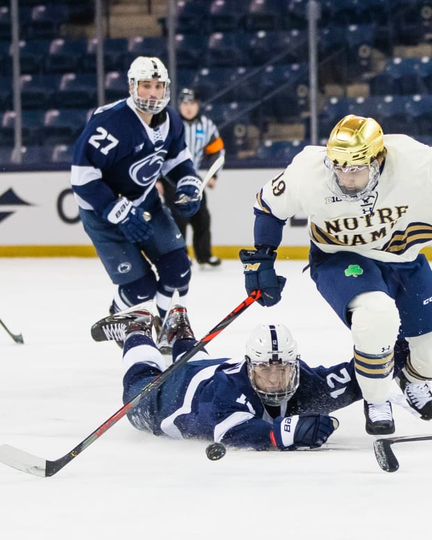 Mar 14, 2021; South Bend, Indiana, USA; Notre Dame s Landon Slaggert (19) gets past Penn State's Bobby Hampton (12) at the Compton Family Ice Arena.