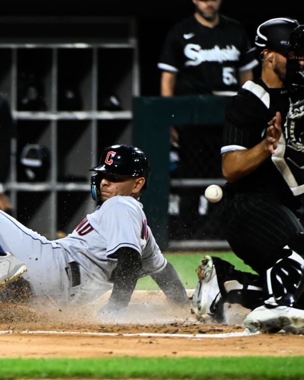 Sep 20, 2022; Chicago, Illinois, USA; Cleveland Guardians second baseman Andres Gimenez (0) scores past Chicago White Sox catcher Seby Zavala (44) during the second inning at Guaranteed Rate Field.