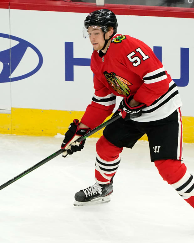 Jan 22, 2021; Chicago, Illinois, USA; Chicago Blackhawks defenseman Ian Mitchell (51) skates with the puck against the Detroit Red Wings during the first period at the United Center.