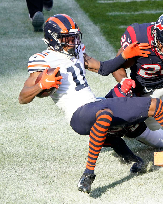 Dec 13, 2020; Chicago, Illinois, USA; Chicago Bears wide receiver Darnell Mooney (11) scores a touchdown against Houston Texans strong safety Justin Reid (20) during the second quarter at Soldier Field.