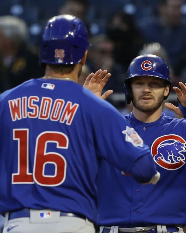 Sep 23, 2022; Pittsburgh, Pennsylvania, USA; Chicago Cubs left fielder Ian Happ (right) greets right fielder Patrick Wisdom (16) crossing home plate after hitting a two-run home run against the Pittsburgh Pirates during the second inning at PNC Park.