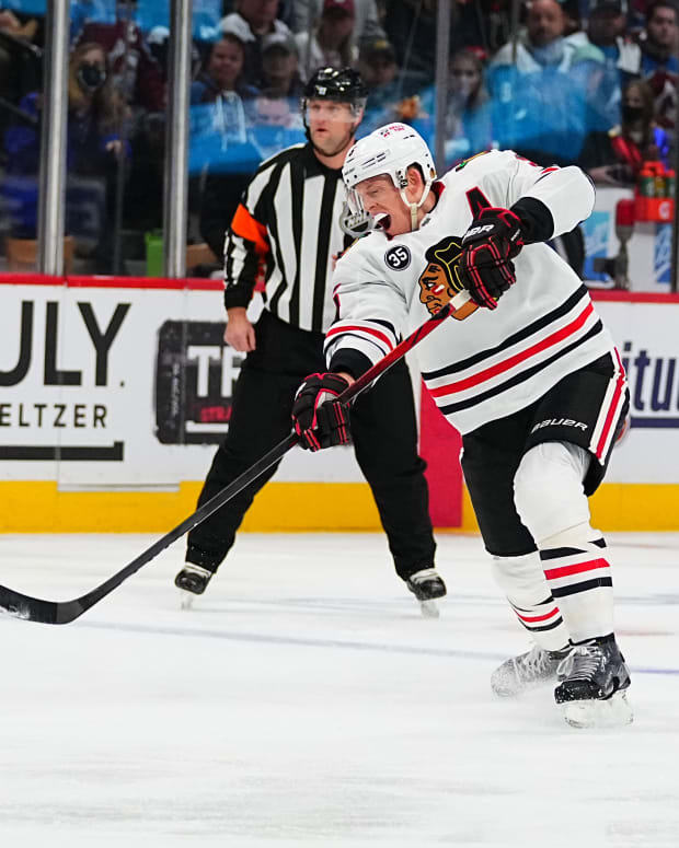 Oct 13, 2021; Denver, Colorado, USA; Chicago Blackhawks defenseman Connor Murphy (5) shoots the puck in the first period against the Colorado Avalanche at Ball Arena.