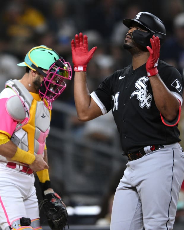 Sep 30, 2022; San Diego, California, USA; Chicago White Sox designated hitter Eloy Jimenez (74) celebrates after hitting a home run as San Diego Padres catcher Austin Nola (left) looks on during the third inning at Petco Park.