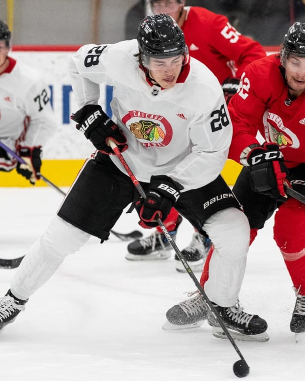 Chicago Blackhawks prospects Colton Dach and Nolan Allan race toward the puck during development camp