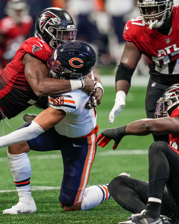 Nov 20, 2022; Atlanta, Georgia, USA; Chicago Bears quarterback Justin Fields (1) is tackled by Atlanta Falcons linebacker Lorenzo Carter (9) during the second half at Mercedes-Benz Stadium.