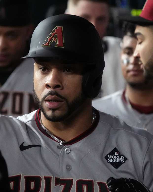 Arizona Diamondbacks outfielder Tommy Pham high fives teammates in the dugout during the 2023 World Series.