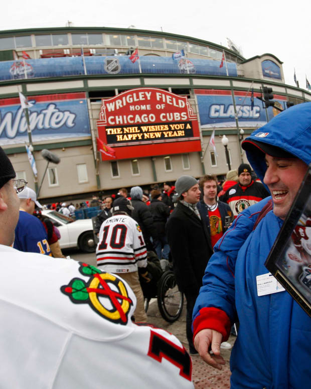 Jan 1, 2009; Chicago, IL, USA; A man sells commemorative plaques to fans before the Winter Classic between the Chicago Blackhawks and Detroit Red Wings at Wrigley Field.