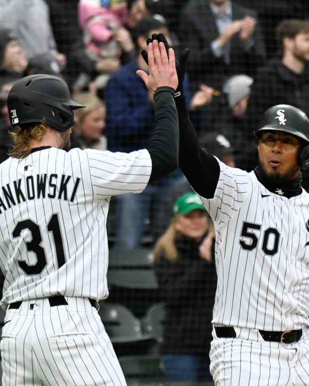 Mar 27, 2025; Chicago, Illinois, USA; Chicago White Sox third base Lenyn Sosa (50) high fives Chicago White Sox outfielder Travis Jankowski (19) after he hits a two run home run against the Los Angeles Angels during the eighth inning at Guaranteed Rate Field.