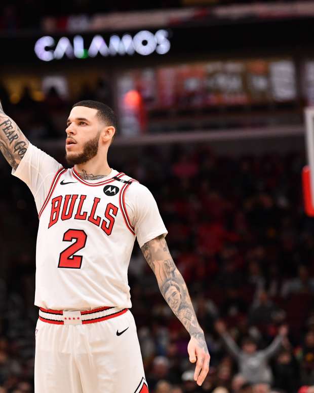 Feb 28, 2025; Chicago, Illinois, USA; Chicago Bulls forward Lonzo Ball (2) hits a three-point shot against Toronto Raptors guard Jamal Shead (23) during overtime at the United Center.