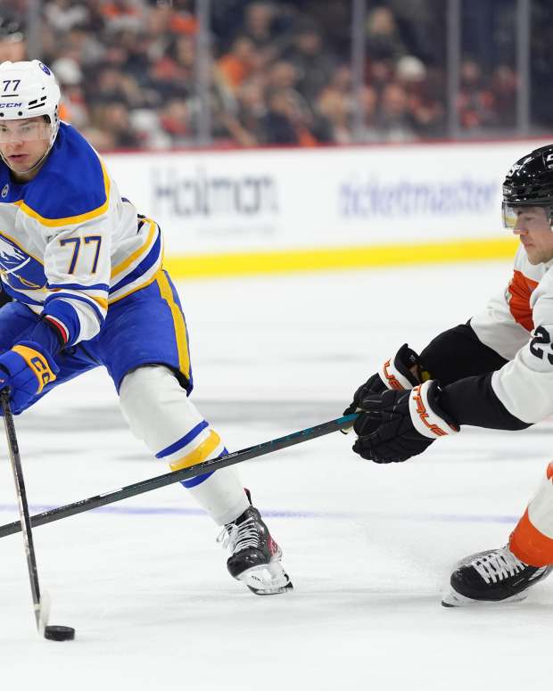 Mar 29, 2025; Philadelphia, Pennsylvania, USA; Buffalo Sabres right wing JJ Peterka (77) controls the puck against Philadelphia Flyers center Ryan Poehling (25) in the third period at Wells Fargo Center.