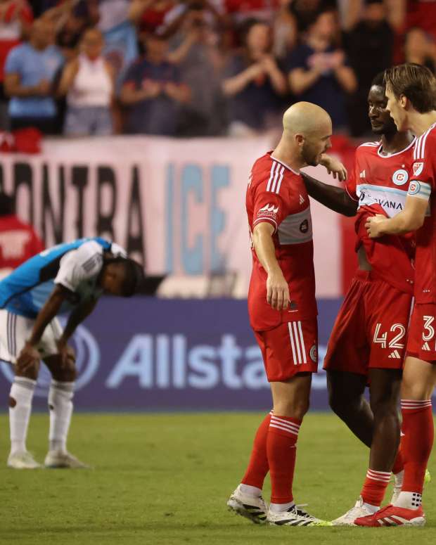 Jun 28, 2025; Chicago, Illinois, USA; Chicago Fire defender Andrew Gutman (15), midfielder Djé D'Avilla (42) and defender Jack Elliott (3) celebrate a win over Charlotte FC at Soldier Field. Mandatory Credit: Talia Sprague-Imagn Images