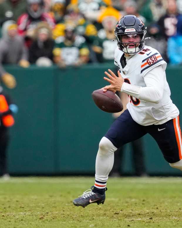 Jan 5, 2025; Green Bay, Wisconsin, USA; Chicago Bears quarterback Caleb Williams rushes with the football during the second quarter against the Green Bay Packers at Lambeau Field. Mandatory Credit: Jeff Hanisch-Imagn Images