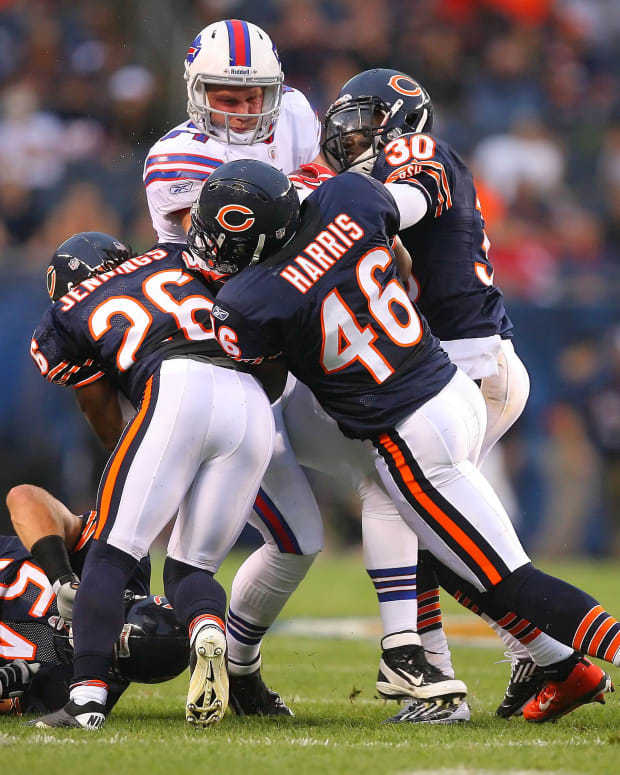 Aug 13, 2011; Chicago, IL, USA; Buffalo Bills tight end Scott Chandler (84) is tackled by Chicago Bears cornerback D.J. Moore (30), linebacker Brian Urlacher (54), cornerback Tim Jennings (26) and safety Chris Harris (46) during the first quarter of a preseason game at Soldier Field. Mandatory Credit: Dennis Wierzbicki-USA TODAY Sports