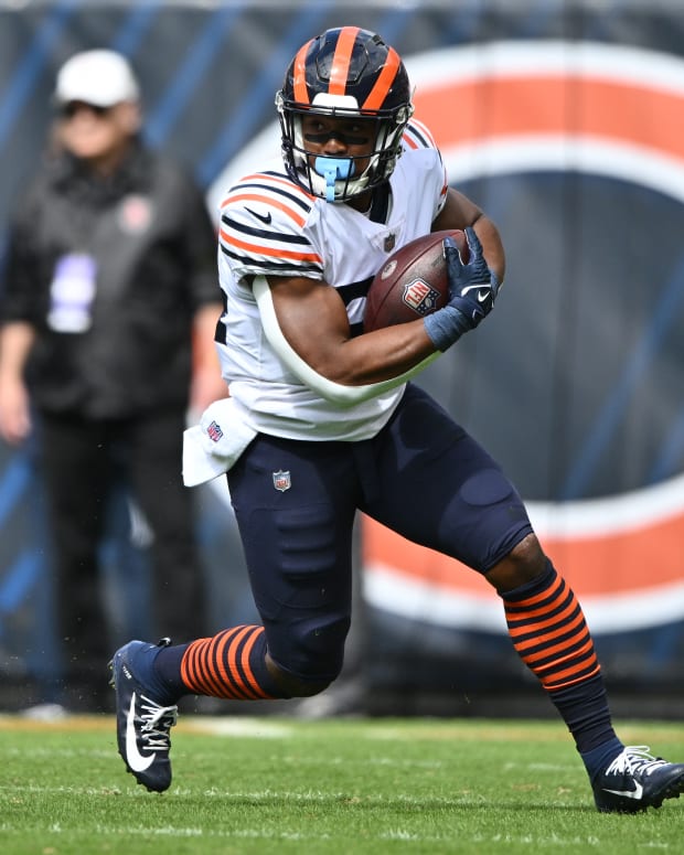 Sep 25, 2022; Chicago, Illinois, USA; Chicago Bears running back Khalil Herbert (24) looks for running room after catching a pass in the first quarter against the Houston Texans at Soldier Field.