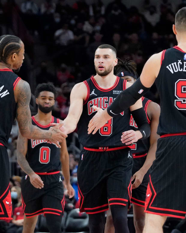 Dec 26, 2021; Chicago, Illinois, USA; Chicago Bulls guard Zach LaVine (8) celebrates a three point basket against the Indiana Pacers with forward DeMar DeRozan (11) and center Nikola Vucevic (9) during the second half at United Center.
