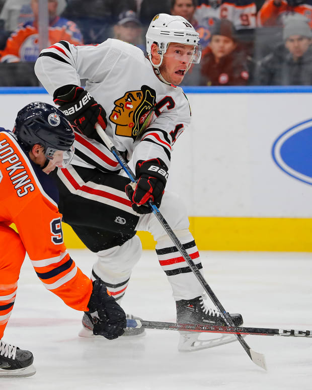 Feb 11, 2020; Edmonton, Alberta, CAN; Edmonton Oilers forward Ryan Nugent-Hopkins (93) tries to block a shot by Chicago Blackhawks forward Jonathan Toews (19) during the second period at Rogers Place.