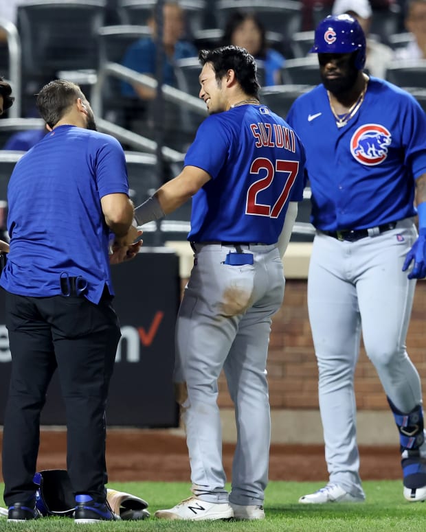 Sep 14, 2022; New York City, New York, USA; Chicago Cubs right fielder Seiya Suzuki (27) reacts as he gets tended to by a trainer after being hit by a pitch during the ninth inning against the New York Mets at Citi Field.