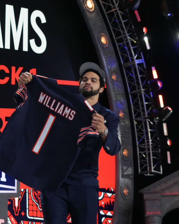 Apr 25, 2024; Detroit, MI, USA; Southern California Trojans quarterback Caleb Williams holds up his jersey after being selected by the Chicago Bears as the No. 1 pick in the first round of the 2024 NFL Draft at Campus Martius Park and Hart Plaza.